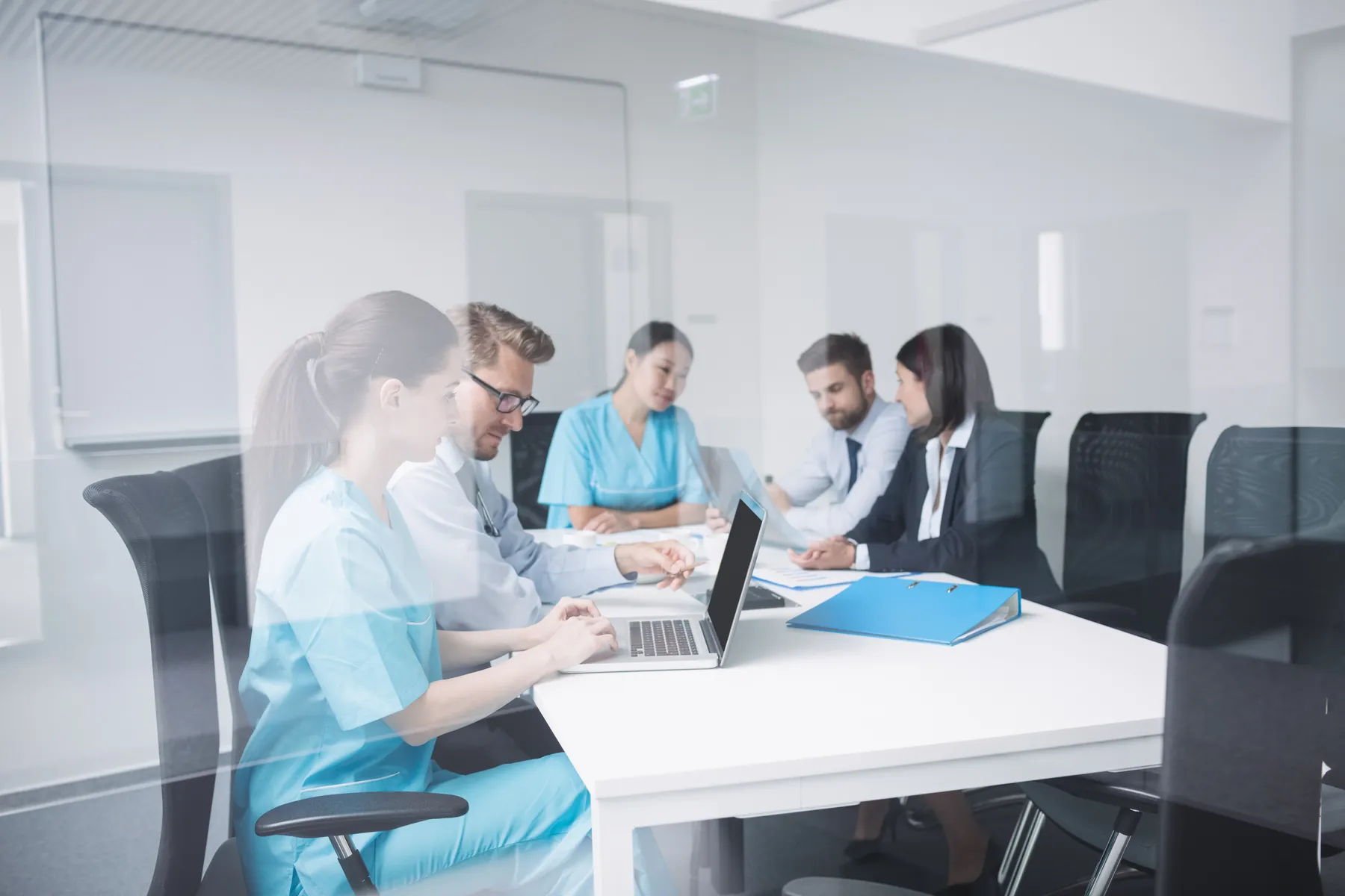 Healthcare professionals reviewing contracts